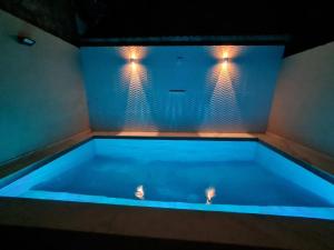 eine blaue Badewanne mit zwei Lichtern darauf in der Unterkunft A Casa Linda Com Piscina Aquecida churrasqueira wifi pertinho da praia em Itanhaém in Itanhaém + 37 Fotos