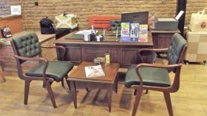 a desk with a table and two chairs and a table and a desk with at Miss City Hotel Taksim in Istanbul