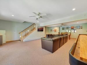 a living room with a couch and a ceiling fan at Holy Island Getaway in East Jordan