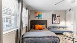 a small bedroom with a bed and a window at Cozy Efficiency Studios Close to Downtown and Domain in Austin