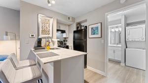 a kitchen with a counter and a black refrigerator at Cozy Efficiency Studios Close to Downtown and Domain in Austin