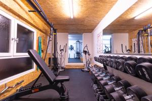 a gym with a row of chairs and tread machines at Ferienwohnungen Panorama Harrys Bike Tours in Villach