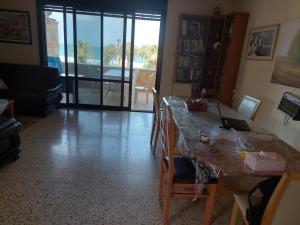 a living room with a table with a laptop on it at First Sea Line Apartment, Acre - amazing coastal view in heart of Akko in Acre