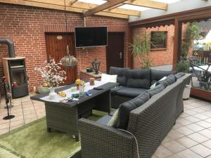 a patio with a couch and a table and chairs at Ingrid Merkle aus Neckarsulm in Karby