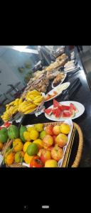 a table topped with lots of different types of food at Hotel Dal Gobo in Ponta Grossa
