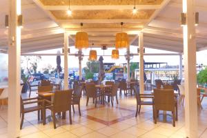 a dining area with tables and chairs in a restaurant at Galini Hotel Bed and Breakfast in Skala