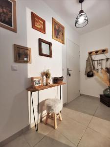 a room with a table and a stool and a door at SEMNOZ & LAC - WIFI - Parking - Balcon - Centre-ville in Sévrier