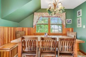 a dining room with a wooden table and chairs at Roxbury Retreat in Roxbury
