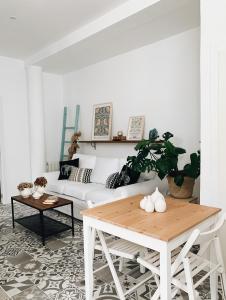 a living room with a white couch and a table at Estudio 33 in San Juan de la Arena