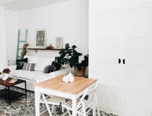 a living room with a white couch and a table at Estudio 33 in San Juan de la Arena