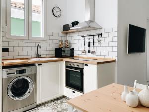 a kitchen with a washing machine and a sink at Estudio 33 in San Juan de la Arena +38 photos