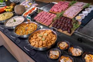 a buffet of different types of food on a table at Villa Dynamic Els Ports Resort in Arnés +33 photos