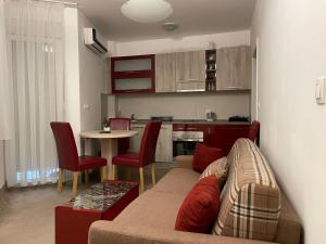 a living room with a couch and a table at Holiday Wing Apartment 2 in Jagodina