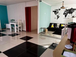 a living room with a black and white tiled floor at Hostal Avenue in La Serena