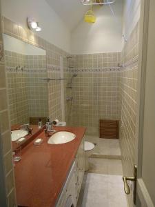 Un baño con dos lavabos, un inodoro y una ducha. en Gîte Desvergnes, en Tours