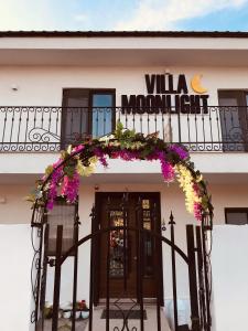a building with a balcony with a wreath on it at Casa Moonlight 2 Mai in 2 Mai +8 photos
