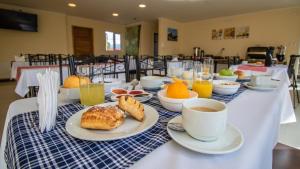a table topped with cups of coffee and pastries at Trotamundos in Puerto Natales