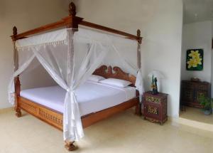 Ein Bett oder Betten in einem Zimmer der Unterkunft KARANG SARI Guesthouse