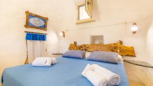 A bed or beds in a room at Trullo Mmammineddhu by Salento Affitti