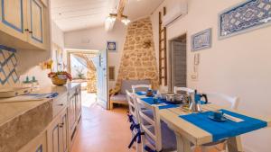 A kitchen or kitchenette at Trullo Mmammineddhu by Salento Affitti