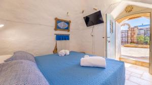 A bed or beds in a room at Trullo Mmammineddhu by Salento Affitti