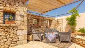 A seating area at Trullo Mmammineddhu by Salento Affitti