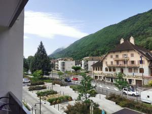 a view of a town with a mountain in the background at SEMNOZ & LAC - WIFI - Parking - Balcon - Centre-ville in Sévrier