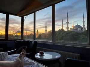 a room with a view of theultan ahmad mosque seen through a window at Optimist Hotel in Istanbul