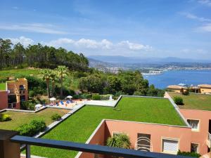 a view from the balcony of a house with a green roof at VUE MER ET ESTEREL SUR LA BAIE DE CANNES in Théoule-sur-Mer