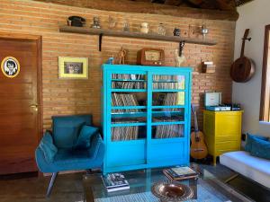 a room with a blue book shelf filled with records at Flores de Cunha in Cunha
