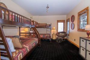a bedroom with two bunk beds and a desk at Mountainside Manor with Hot Tub in Edwards
