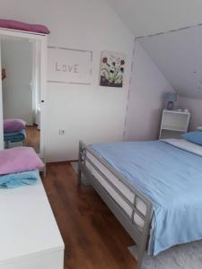 una camera con un letto e un cartello che dice amore di Apartman Breza a Zagabria