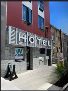 a hotel sign on the side of a building at Wheeler Hotel in Bronx