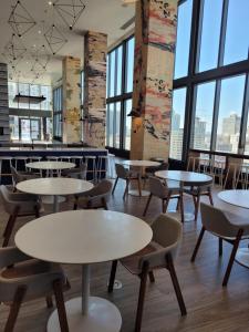 a cafeteria with tables and chairs and large windows at Lovely Condo Unit in Miami