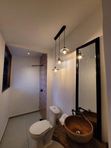 a bathroom with a wooden sink and a toilet at Casa Ensueño Hogar Boutique in Guaduas