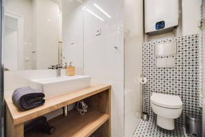 a bathroom with a white sink and a toilet at Studio Mala Strana - Prague historical center in Prague