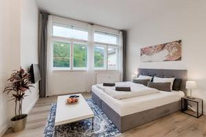 a bedroom with a bed and a large window at Studio Mala Strana - Prague historical center in Prague