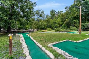 a miniature golf course in a park with trees at Drummer Boy Camping Resort in Gettysburg +5 photos