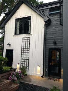 a white and black house with a garage at Stone's Throw Stratford in Stratford