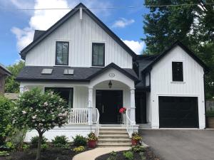 a white house with a black roof at Stone's Throw Stratford in Stratford