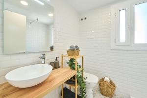 a bathroom with a white sink and a mirror at Lovely 2 bedroom apartment with terrace in Blanes