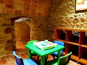 a table and chairs with a cake on top of it at Masía para grupos con piscina privada-28 pax in Girona +27 photos