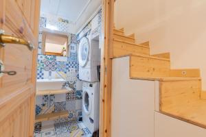 a bathroom with a washer and dryer in a tiny house at Casa Materdei in Naples