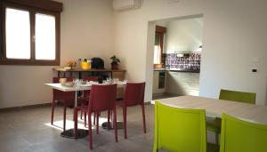 a kitchen with a table and colorful chairs at Anima Franca Bed and breakfast in Greve in Chianti