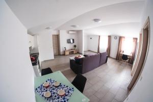 a living room with a couch and a table at Apartments Time For Sea in Koper