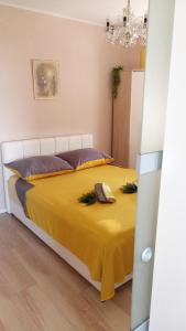 a bedroom with a bed with a yellow blanket at Luxor4 in Kaštela +7 photos