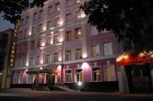 a pink building with lights on the side of it at Aurora Premier Hotel in Kharkiv