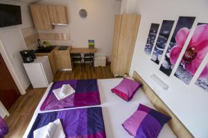 ein Zimmer mit zwei Betten und einer Küche in der Unterkunft Apartmani Kordić in Rab