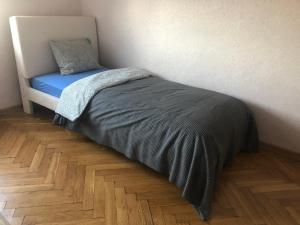 a bed with a blue blanket and a pillow on it at Blue River - Plac Legionow in Wrocław
