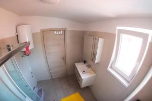 a bathroom with a sink and a toilet and a window at Apartments Time For Sea in Koper +23 photos